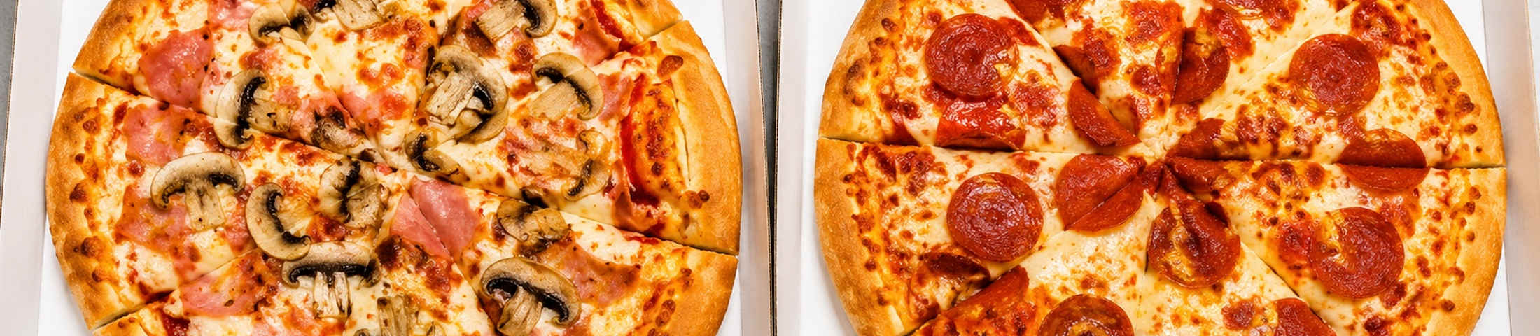 Fresh pizzas in takeaway boxes
